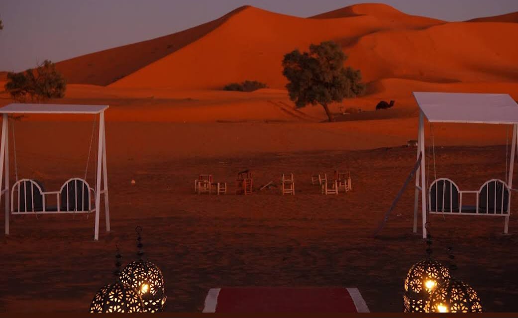 Grand Dune Luxury Camp beside the red Erg Chebbi dunes at sunset